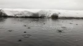 Cool slow motion footage of rain hitting a winter lake
