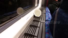 A cup looks like it is haunted as it moves around on a London Underground train.