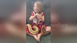 Newsflare Edit - Adorable three-year-old plays with pythons