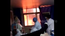 Doctor continues treating patient as fire rages outside hospital