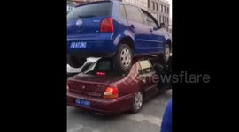 Car ends up on top of another car following accident