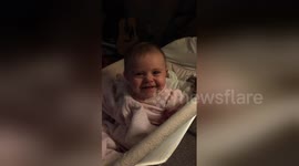 This baby stops crying when she looks at the camera