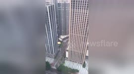 Man BASE jumps from the top of a skyscraper in China