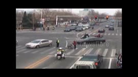 Chinese police officers help elderly woman cross the road