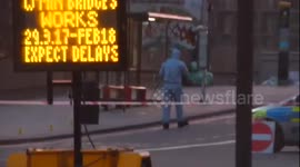 Forensics officers work on Westminster Bridge following terror incident