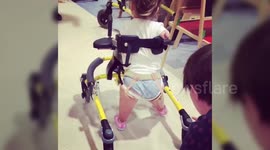 A toddler who lost all her limbs to meningitis takes her first steps