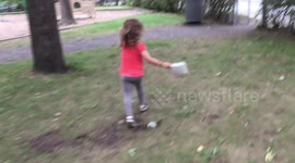 Squirrel surprises young girl by hiding in public bin, then jumping out
