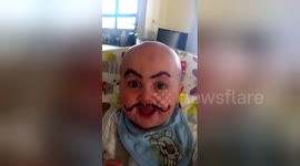 Father draws moustache and eyebrows on baby while mum is away