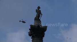 Police helicopter hovering on top of Nelson's column