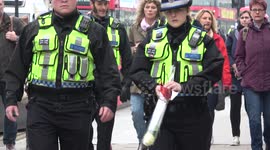 Police officers pay respect to terror victims and fallen colleague outside Parliament