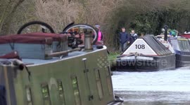Spring time walkers on canal with boats and wildlife
