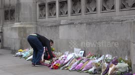 GV of tributes being left outside Parliament on Friday morning