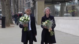 Sombre Mayor Sadiq Khan shakes hands with police and delivers flowers