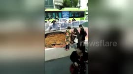 Bus causes deep sinkhole to open on road in China