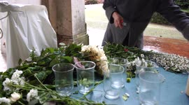 A florist preparing flowers for the wedding catering on a rainy day in Italy, 4K