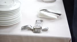 Wedding catering preparation, a waiter putting down forks for the appetisers , 4K