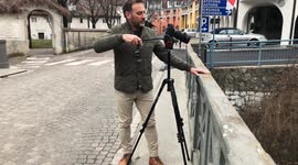 Videographer shooting video with his tripod in Italy