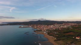 Aerial shot, incredibly beautiful calm sea in Italy in the sunset light with lots of clouds, filmed with drone, 4K