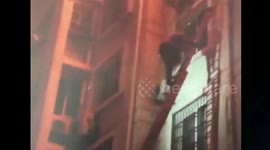 Firefighters catch mother and daughter falling down ablaze house on fifth floor