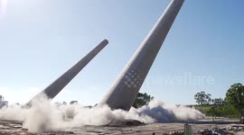 Two giant power station chimneys demolished in controlled explosion