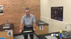 Teacher flips a giant pancake in class using electric frypan