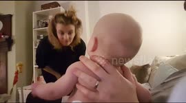 Baby finds mum's bun hilarious