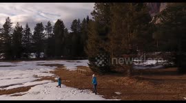 Mother and daughter playing snow balls in the Alps  mountains in Italy  in winter,4K