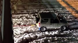 Suzuki tows huge truck through ice and snow.