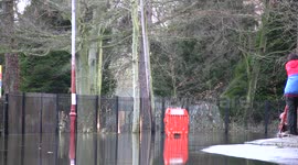 Wakeboarder rides a flooded road in Staines