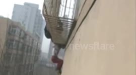 Boy Dangles from Balcony in China