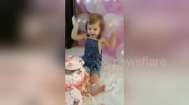 Baby girl destroys birthday cake