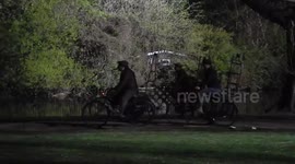 Chimney sweeps ride across St James' Park on Mary Poppins filming set