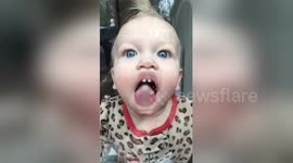 Baby tries to 'eat' a glass door