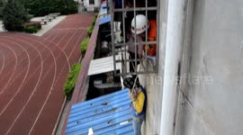 Boy helps firefighters rescue girl stuck in window security net