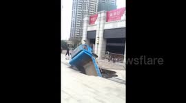 Lorry falls into sinkhole in southern China