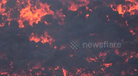 Rivers of lava flow onto slopes of Volcano Etna