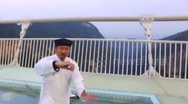 Tai Chi master gives martial arts performance on the world's highest glass-bottom bridge