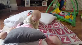 Twin babies playing peekaboo