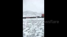 Snow disrupts traffic and traps 200 vehicles on road in northern China