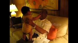 Cute baby 'attacks' grandfather