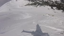 Snowboarder narrowly escapes being swiped by an avalanche