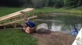 Man attempts to jump pond on bike, it ends badly