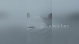 Car buried in snow during blizzard in Canada