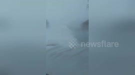 Car buried in snow during blizzard in Canada