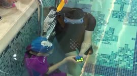 Girl, 11, breaks world record by solving Rubik's Cube with one hand underwater