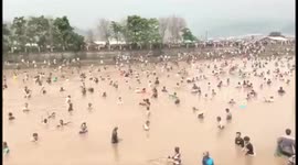 Tens of thousands of people catch fish in river