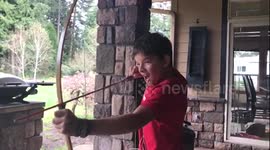 Boy pulls his tooth out with a bow and arrow