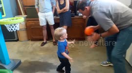 3 year old plays basketball with grandpa