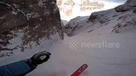 Skier speeds down steep Dolomites couloir in Italy