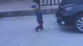 Toddler survives being run over by car